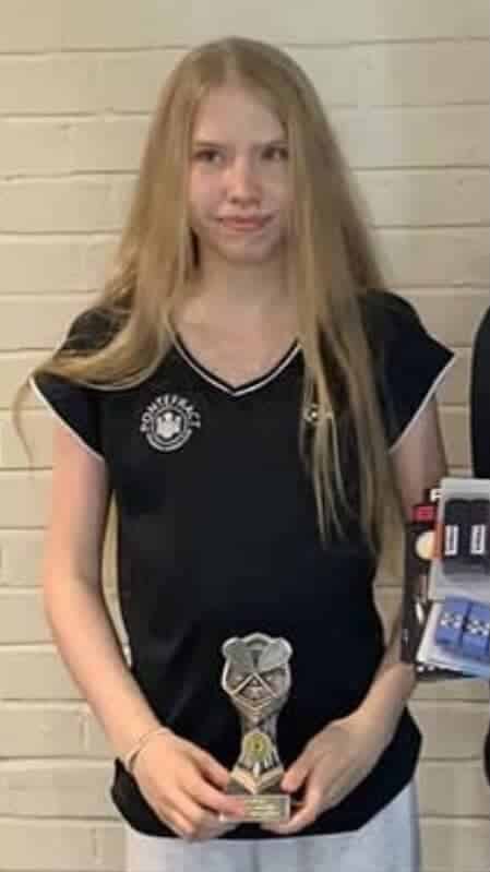 Sienna holding her squash trophy